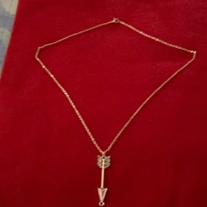 Rose gold necklace with arrow charm.